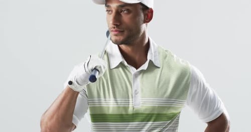 Man Wearing Golf Apparel Holding Club Over Shoulder