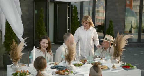 Family Celebrates Birthday Outdoors at a Festive Table