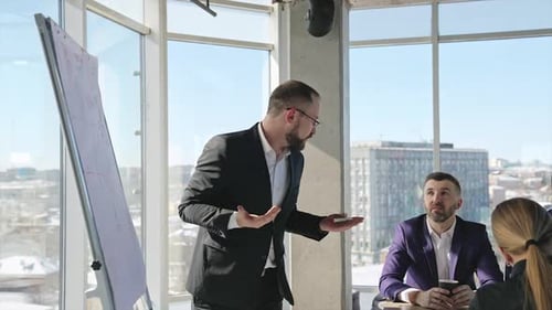 Man Presents Business Data in Modern Office