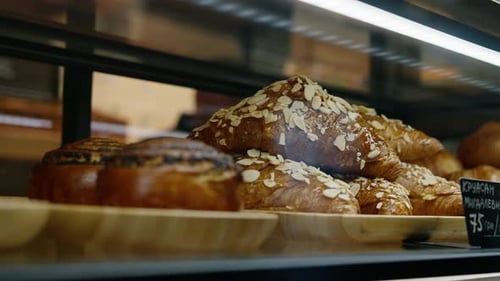 Bun with almonds on the counter of the shop - bakery