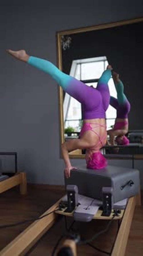 Discover a Bright and Inviting Pilates Studio Featuring a Reformer and Lush Indoor Plants