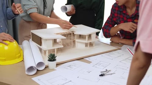 Architects Team Reviewing House Model and Blueprints