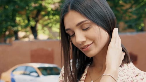 Woman Posing in Floral Dress in Urban Setting