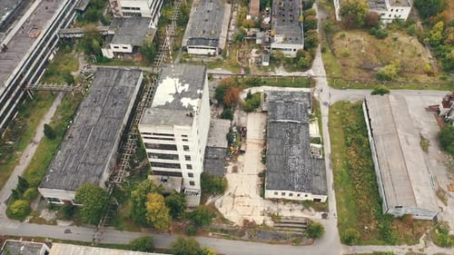 Aerial view of industrial destroyed city buildings. View from above of ruined and abandoned factory.