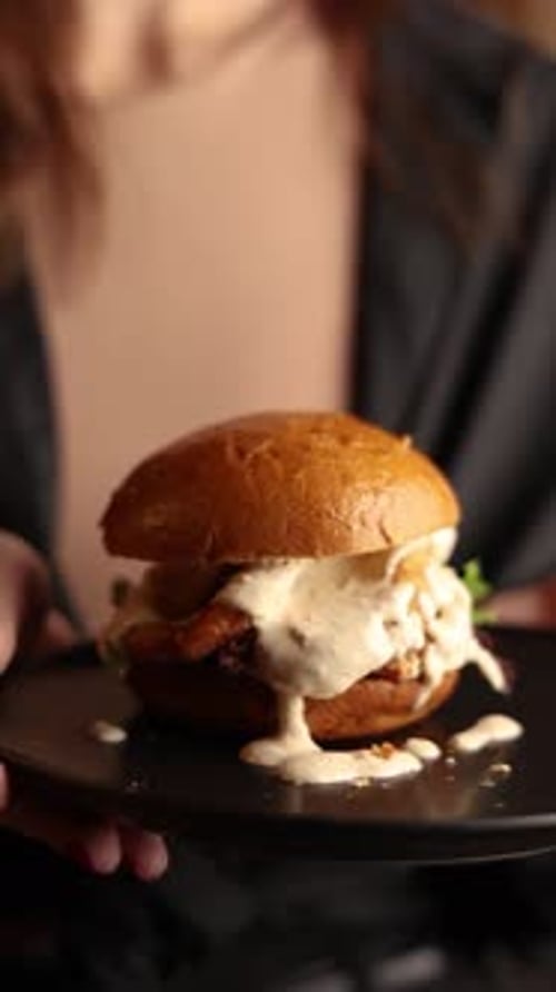 delicious hamburger with cutlet, cheese, cabbage, breaded squid rings. Close up