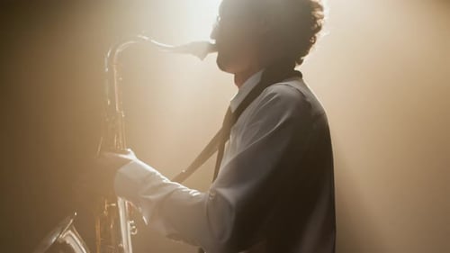 Passionate Male Jazz Player Performing Solo on Saxophone Onstage