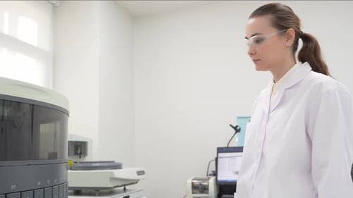Female Scientist Working with Automated Lab Equipment