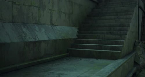 Staircase Leading to Unknown Destination in a Dimly Lit Area