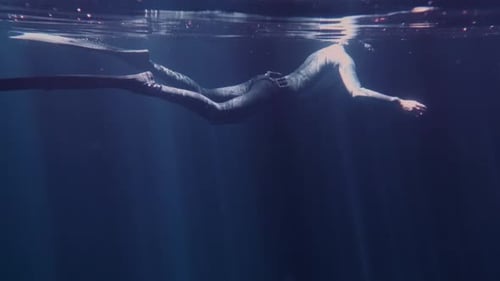 Person Freediving in Ocean with Fins and Wetsuit