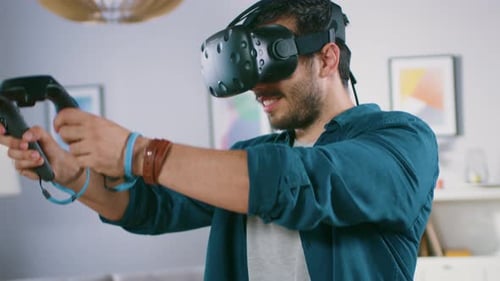 Man smiles playing virtual reality in living room