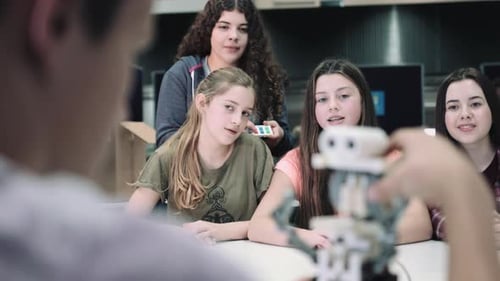 Five Children working with small robot at school