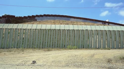 Double border fence between USA and Mexico in San Ysidro California, Slowly panning to the left.