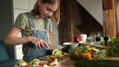 Girl Slices Avocado in Bright Home Kitchen