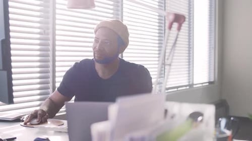 Man working at desk in bright office