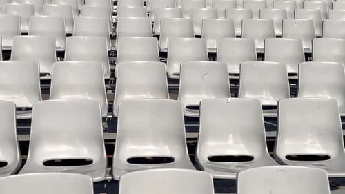 Empty Rows of Plastic Seats or Chairs in the Stands or Stadium Lots of Empty Seats for Spectators in