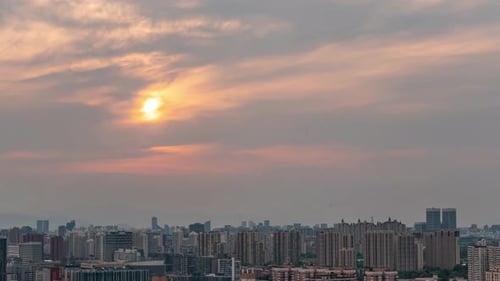 Bird's-eye view of Bright orange sunset sky over iconic skyline landmark skyscraper buildings city
