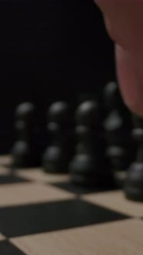 Vertical of The First Standard Move By the E7E5 Chess Black Pawn on Checkerboard
