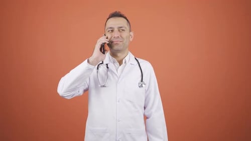 Friendly Doctor Talking on Phone in Studio