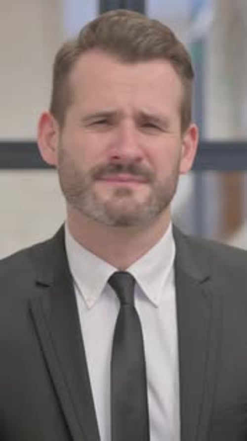 Man in Suit Gesturing No with Crossed Arms