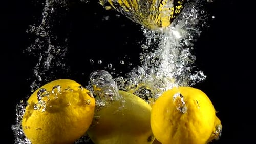 Lemons Splashing into Water in Slow Motion