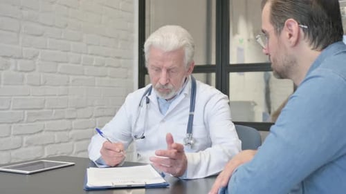 Doctor Consults with Patient in Office Setting