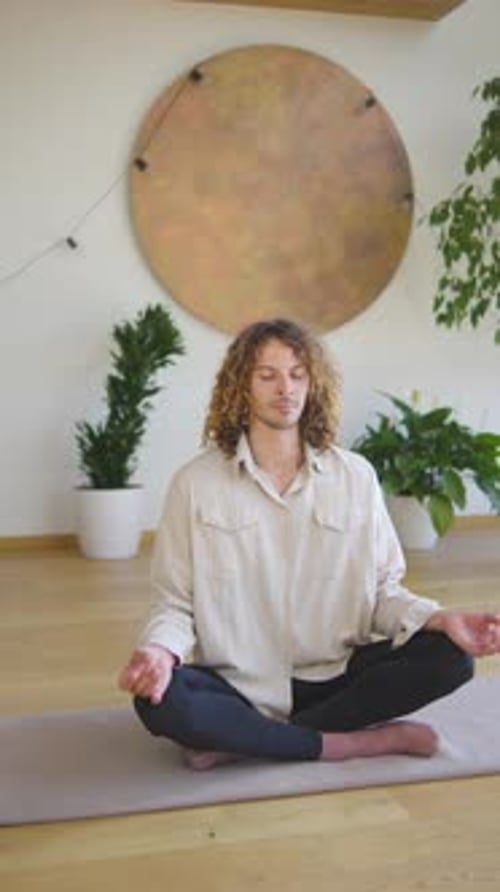 Man Meditating on Yoga Mat Indoors