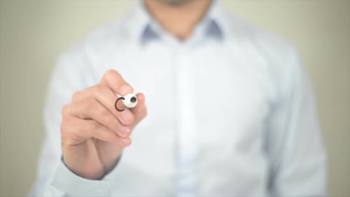 Man Writes Cooperation on Clear Surface With Marker