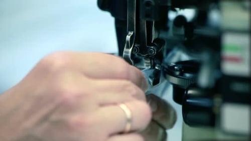 Close Up Woman Hands Sewing Fabric on Sewing Machine. Industrial Equipment At