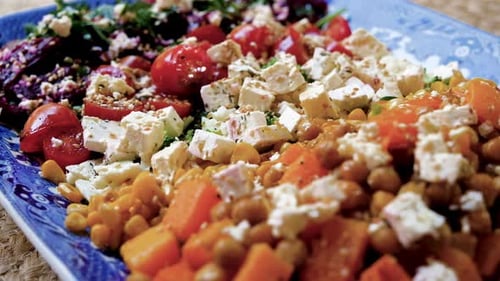 Mouth-watering salad of fresh mixed vegetables; close-up slider shot
