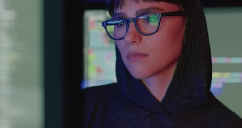 Woman Looking at Computer Screen at Night