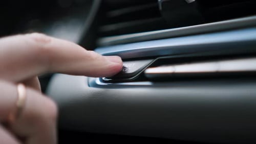 Man Hand Presses a Rectangular Engine Start Button in a Modern Car
