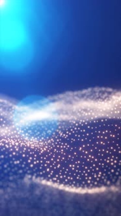 Éclat rayonnant de lumière bleue douce au-dessus d'un champ scintillant de particules incandescentes sur un gradient froid