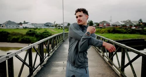 Stretching, fitness and man on bridge in city for running, marathon training and workout