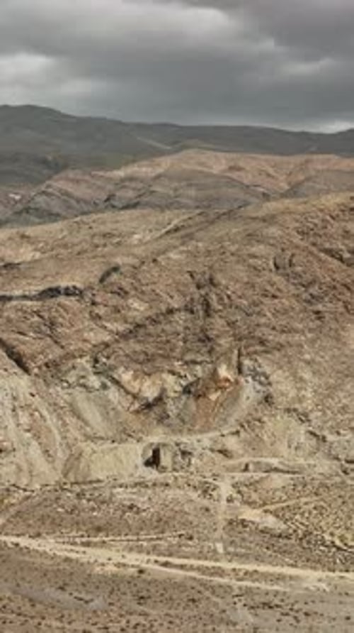 Aerial view of rugged Nevada terrain under a cloudy sky