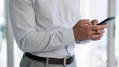 Adult Male Typing on Cellphone Indoors