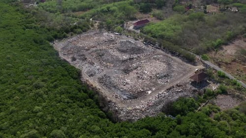 Rubbish tip, landfill, waste area in Lembongan Bali drone medium pan shot