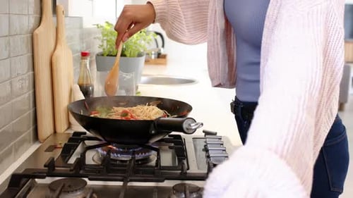 Woman Cooking Stir Fry at Home in Kitchen