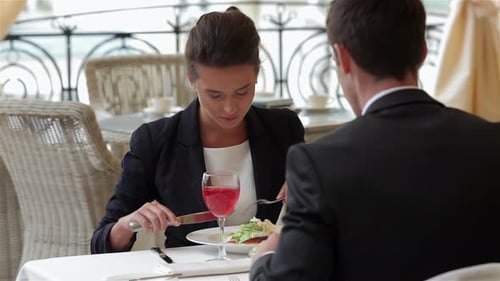 Woman Enjoys Business Lunch at Restaurant Table