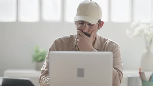 Man Working at Laptop in Bright Modern Office