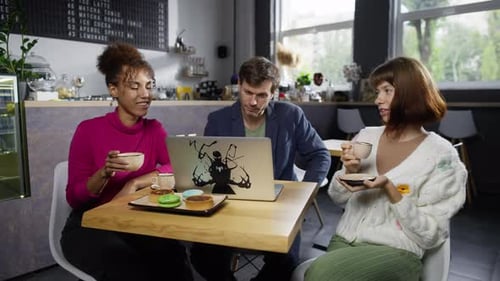 A Group of People in a Cafe at an Online Business Meeting Over Coffee