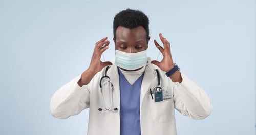 Face mask, doctor and black man with ok sign, support and healthcare with feedback on a blue studio