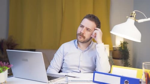 Home office worker man coming up with idea looking at camera.