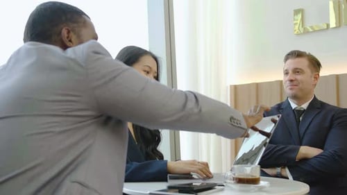 Business Professionals Discussing Project Around Laptop