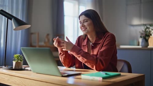 Woman Video Calling on Laptop at Home Desk