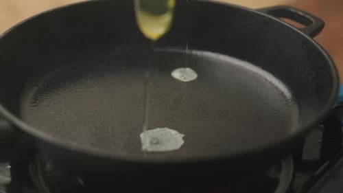 Frying Eggs in Skillet for Breakfast