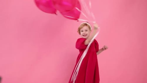 A Young Girl is Holding Four Red Balloons in Her Hand
