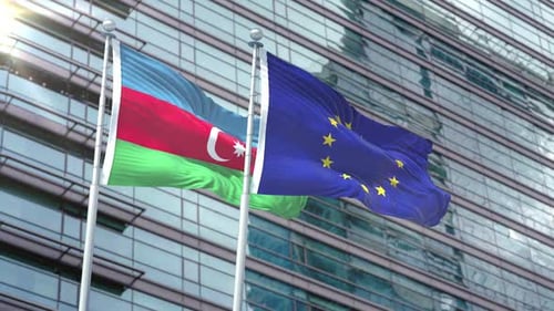 Azerbaijan and European Union Flags Waving Against Corporate Building