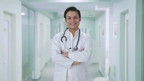 Smiling Doctor Stands Confidently in Hospital Setting
