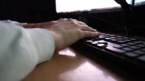 Male Fingers Typing Text on Computer Keyboard at Evening Arms of Young Man Entering Information with