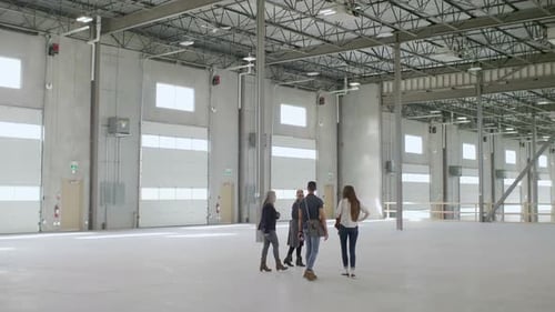 Group Tour of Empty Warehouse Interior Space
